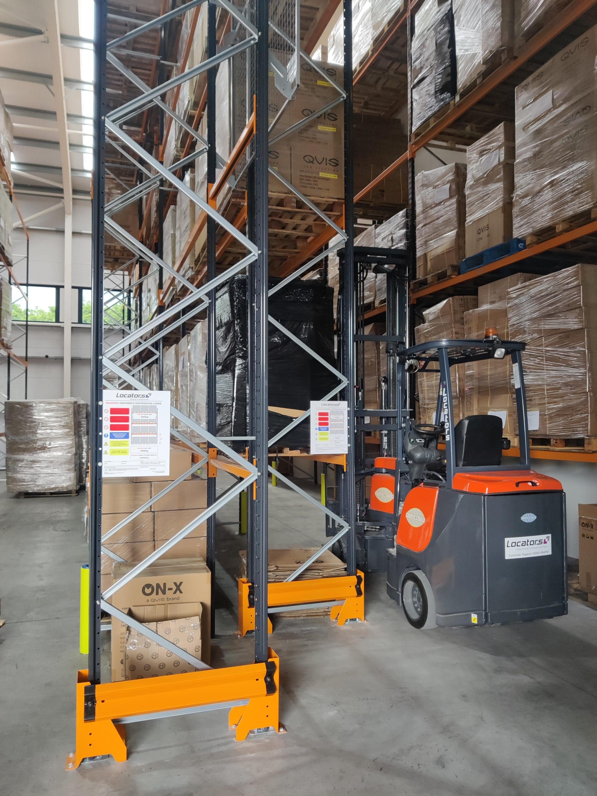 Qvis Lighting's new pallet racking, complete with anti-collapse mesh and partitioning, as well as barriers and rack protection. Also pictured is their refurbished Aisle-Master 15SE.